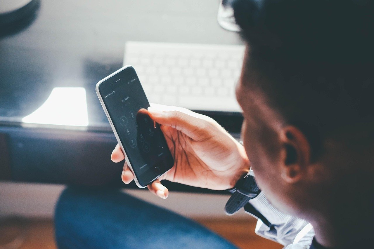A person holding a phone up to check a call screen, the kind of enquiry that is easy to miss in website tracking