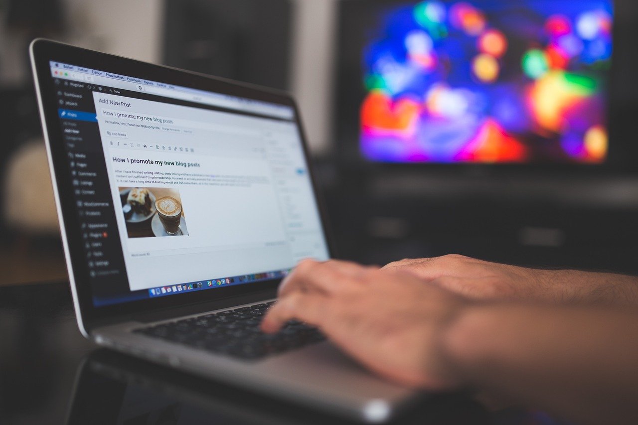 Writing a new blog post on a laptop
